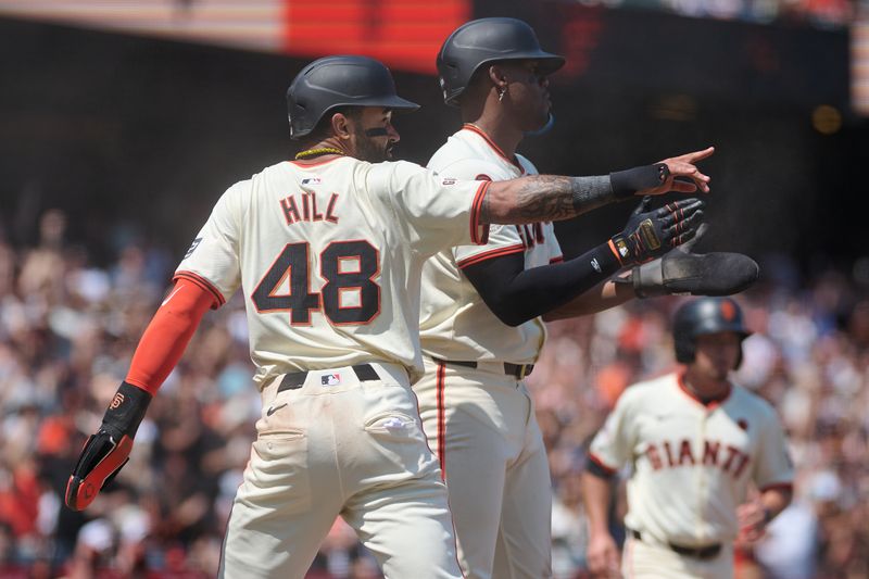 Jul 28, 2024; San Francisco, California, USA; San Francisco Giants outfielder Derek Hill (48) and designated hitter Jorge Soler (2) gesture toward infielder Matt Chapman (26) (not pictured) after Chapman hit an RBI double against the Colorado Rockies during the sixth inning at Oracle Park. Mandatory Credit: Robert Edwards-USA TODAY Sports