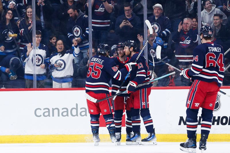 Jan 14, 2025; Winnipeg, Manitoba, CAN;  Winnipeg Jets forward Kyle Connor (81) celebrates with teammates after scoring a goal against the Vancouver Canucks during the first period at Canada Life Centre. Mandatory Credit: Terrence Lee-Imagn Images