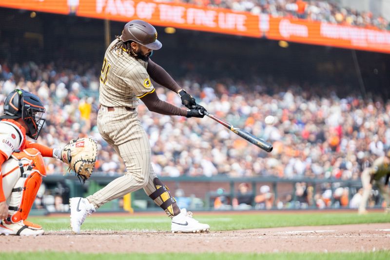 Sep 15, 2024; San Francisco, California, USA; San Diego Padres outfielder Fernando Tatis, Jr. (21) hits a solo home run during the eighth inning against the San Francisco Giants at Oracle Park. Mandatory Credit: Bob Kupbens-Imagn Images