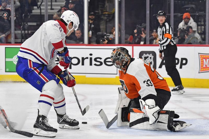 Jan 10, 2024; Philadelphia, Pennsylvania, USA; Philadelphia Flyers goaltender Samuel Ersson (33) makes a save against Montreal Canadiens left wing Juraj Slafkovsky (20) during the second period at Wells Fargo Center. Mandatory Credit: Eric Hartline-USA TODAY Sports