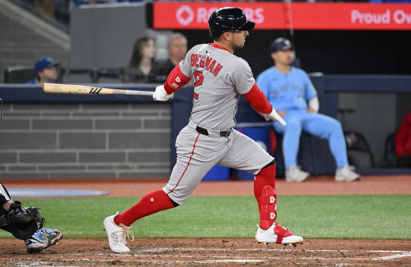 May 1, 2025; Toronto, Ontario, CAN;  Boston Red Sox third baseman Alex Bregman (2) hits a two run RBI double against the Toronto Blue Jays in the fifth inning at Rogers Centre. Mandatory Credit: Dan Hamilton-Imagn Images
