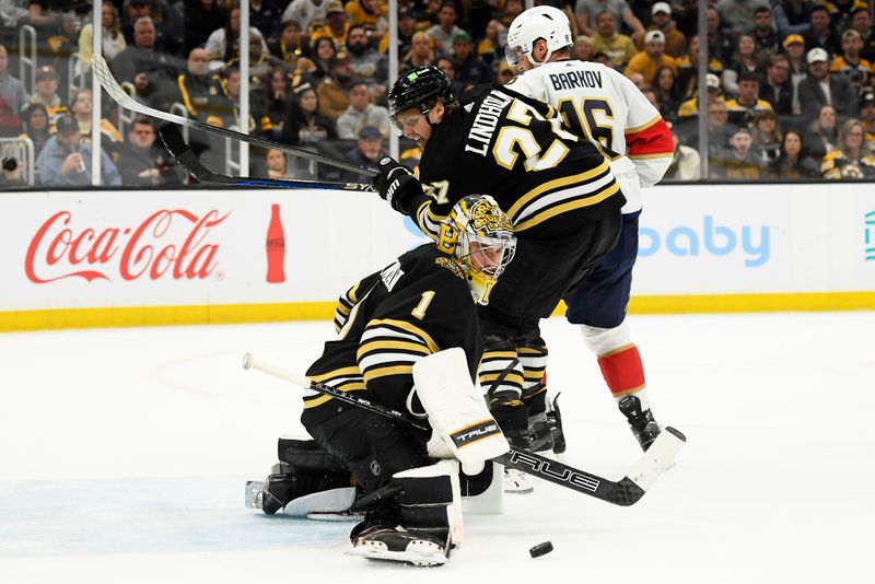 May 12, 2024; Boston, Massachusetts, USA; Boston Bruins goaltender Jeremy Swayman (1) makes a save in front of defenseman Hampus Lindholm (27) and Florida Panthers center Aleksander Barkov (16) during the second period in game four of the second round of the 2024 Stanley Cup Playoffs at TD Garden. Mandatory Credit: Bob DeChiara-USA TODAY Sports