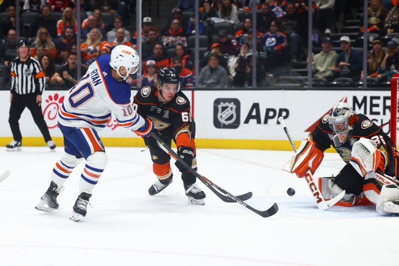 Feb 9, 2024; Anaheim, California, USA; Edmonton Oilers center Derek Ryan (10) shoots against Anaheim Ducks defenseman Jackson LaCombe (60) during the first period of a game at Honda Center. Mandatory Credit: Jessica Alcheh-USA TODAY Sports