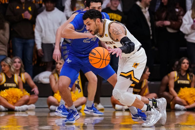 Feb 17, 2023; Laramie, Wyoming, USA; Wyoming Cowboys guard Hunter Maldonado (24) drives against Air Force Falcons guard Jeffrey Mills (24) during the first half at Arena-Auditorium. Mandatory Credit: Troy Babbitt-USA TODAY Sports