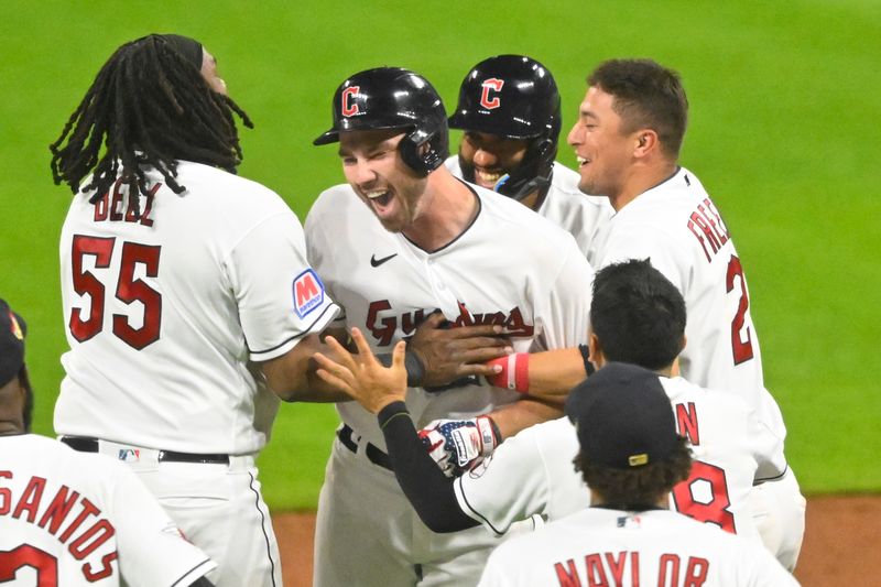 Jul 4, 2023; Cleveland, Ohio, USA; Cleveland Guardians right fielder David Fry (second from left) celebrates his game-winning single in the tenth inning against the Atlanta Bravesb at Progressive Field. Mandatory Credit: David Richard-USA TODAY Sports