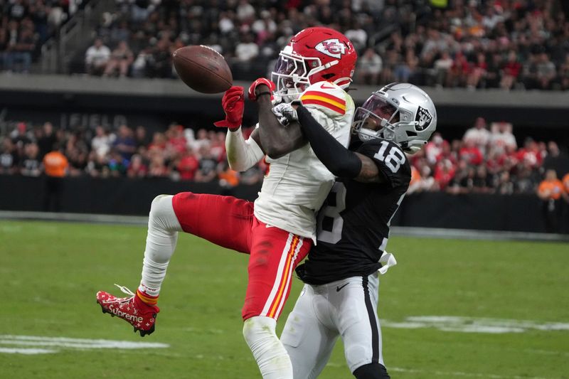 Las Vegas Raiders cornerback Jack Jones (18) breaks up a pass intended for Kansas City Chiefs wide receiver Xavier Worthy during the second half of an NFL football game Sunday, Oct. 27, 2024, in Las Vegas. (AP Photo/Rick Scuteri)