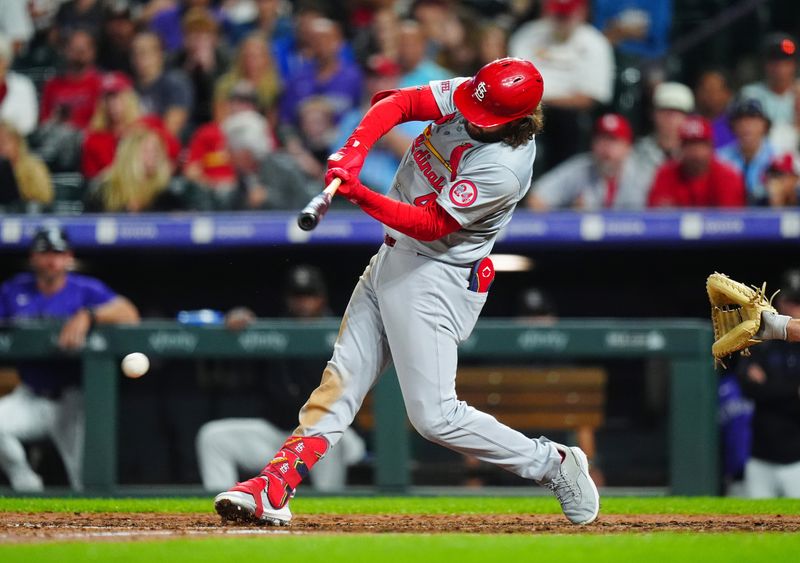 Sep 24, 2024; Denver, Colorado, USA; St. Louis Cardinals outfielder Alec Burleson (41) hits an infield RBI single in the seventh inning against the Colorado Rockies at Coors Field. Mandatory Credit: Ron Chenoy-Imagn Images