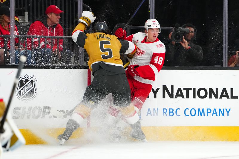 Nov 4, 2025; Las Vegas, Nevada, USA; Vegas Golden Knights defenseman Jeremy Lauzon (5) attempts to check Detroit Red Wings right wing Jonatan Berggren (48) during the first period at T-Mobile Arena. Mandatory Credit: Stephen R. Sylvanie-Imagn Images