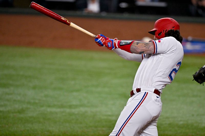 May 16, 2023; Arlington, Texas, USA; Texas Rangers catcher Jonah Heim (28) hits a single and drives in a run against the Atlanta Braves during the sixth inning at Globe Life Field. Mandatory Credit: Jerome Miron-USA TODAY Sports