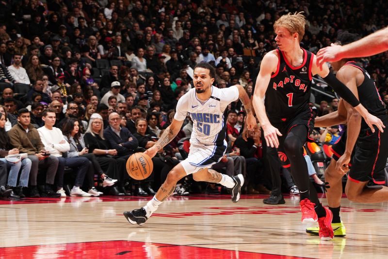 TORONTO, CANADA - JANUARY 3: Cole Anthony #50 of the Orlando Magic handles the ball during the game against the Toronto Raptors on January 3, 2025 at the Scotiabank Arena in Toronto, Ontario, Canada.  NOTE TO USER: User expressly acknowledges and agrees that, by downloading and or using this Photograph, user is consenting to the terms and conditions of the Getty Images License Agreement.  Mandatory Copyright Notice: Copyright 2025 NBAE(Photo by Mark Blinch/NBAE via Getty Images)