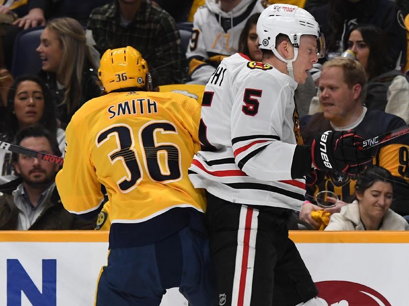 Jan 2, 2024; Nashville, Tennessee, USA; Nashville Predators left wing Cole Smith (36) hits Chicago Blackhawks defenseman Connor Murphy (5) during the first period at Bridgestone Arena. Mandatory Credit: Christopher Hanewinckel-USA TODAY Sports