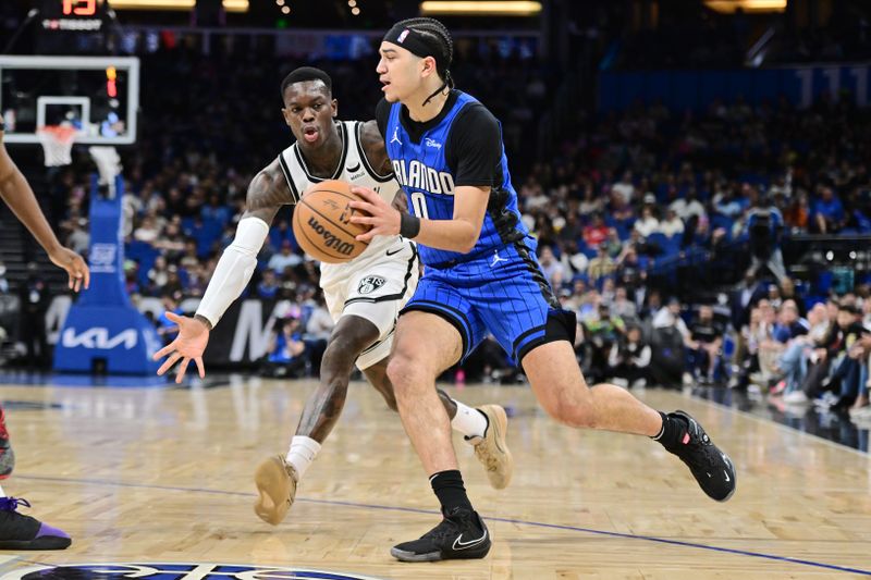 ORLANDO, FLORIDA - FEBRUARY 27: Anthony Black #0 of the Orlando Magic goes to the basket against Dennis Schroder #17 of the Brooklyn Nets in the first half of a game at Kia Center on February 27, 2024 in Orlando, Florida. NOTE TO USER: User expressly acknowledges and agrees that, by downloading and or using this photograph, User is consenting to the terms and conditions of the Getty Images License Agreement. (Photo by Julio Aguilar/Getty Images)