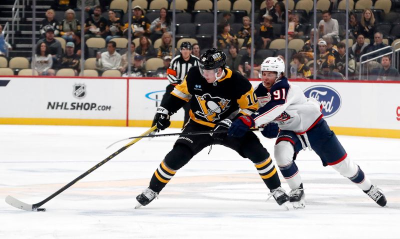 Oct 4, 2024; Pittsburgh, Pennsylvania, USA;  Pittsburgh Penguins defenseman Ryan Graves (27) moves the puck against Columbus Blue Jackets center Kent Johnson (91) during the first period at PPG Paints Arena. Mandatory Credit: Charles LeClaire-Imagn Images