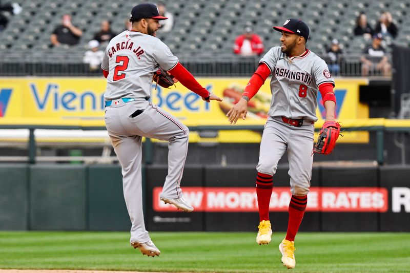 May 14, 2024; Chicago, Illinois, USA; Washington Nationals second baseman Luis García Jr. (2) and outfielder Eddie Rosario (8) celebrate after the game against the Chicago White Sox at Guaranteed Rate Field. Mandatory Credit: Matt Marton-USA TODAY Sports