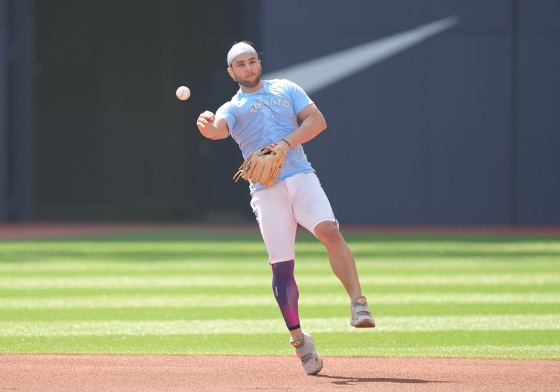 Jun 29, 2023; Toronto, Ontario, CAN; Toronto Blue Jays shortstop Bo Bichette (11) fields balls during batting practice against the San Francisco Giants at Rogers Centre. Mandatory Credit: Nick Turchiaro-USA TODAY Sports