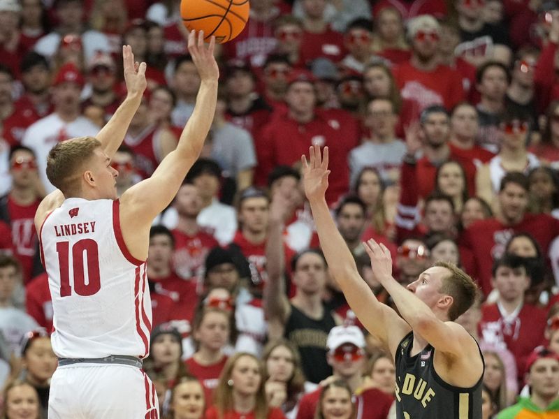 Mar 2, 2023; Madison, Wisconsin, USA; Wisconsin Badgers guard Isaac Lindsey (10) shoots against Purdue Boilermakers guard Fletcher Loyer (2) during the first half at the Kohl Center. Mandatory Credit: Kayla Wolf-USA TODAY Sports