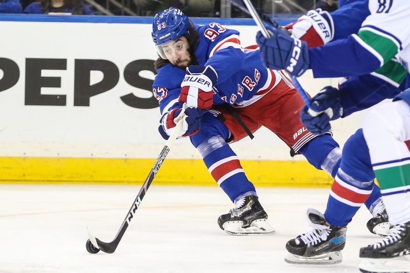 Jan 8, 2024; New York, New York, USA;  New York Rangers center Mika Zibanejad (93) reaches for the puck in the first period against the Vancouver Canucks at Madison Square Garden. Mandatory Credit: Wendell Cruz-USA TODAY Sports