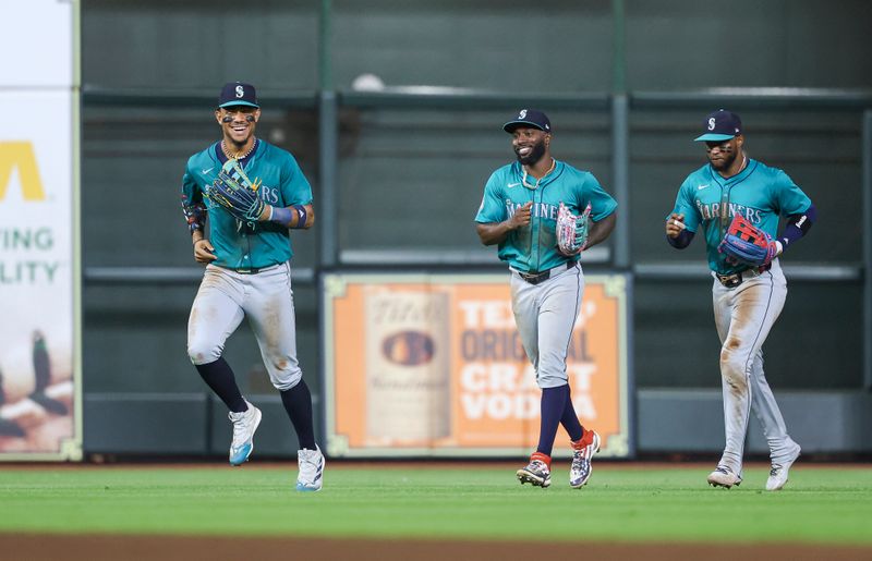 Sep 23, 2024; Houston, Texas, USA; Seattle Mariners center fielder Julio Rodriguez (44) jogs off the field with left fielder Randy Arozarena (56) and right fielder Victor Robles (10) after the game against the Houston Astros at Minute Maid Park. Mandatory Credit: Troy Taormina-Imagn Images