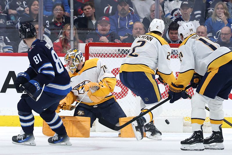 Jan 7, 2025; Winnipeg, Manitoba, CAN; Winnipeg Jets left wing Kyle Connor (81) scores on Nashville Predators goaltender Juuse Saros (74) in the first period at Canada Life Centre. Mandatory Credit: James Carey Lauder-Imagn Images