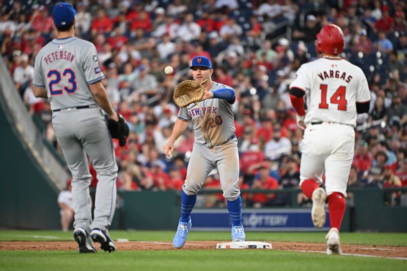 Jul 1, 2024; Washington, District of Columbia, USA; New York Mets first baseman Pete Alonso (20) catches the ball from starting pitcher David Peterson (23) at first base in front of Washington Nationals second baseman Ildemaro Vargas (14) for an out during the sixth inning at Nationals Park. Mandatory Credit: Rafael Suanes-USA TODAY Sports