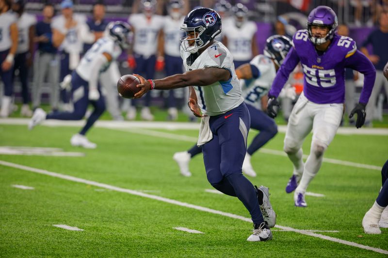 Tennessee Titans quarterback Malik Willis (7) hands off the ball against the Minnesota Vikings in the second half of a preseason NFL football game, Saturday, Aug. 19, 2023, in Minneapolis. (AP Photo/Bruce Kluckhohn)