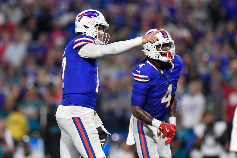 Buffalo Bills quarterback Josh Allen (17) signals next to running back James Cook (4) during the first half of an NFL football game against the Jacksonville Jaguars, Monday, Sept. 23, 2024, in Orchard Park, NY. (AP Photo/Adrian Kraus)