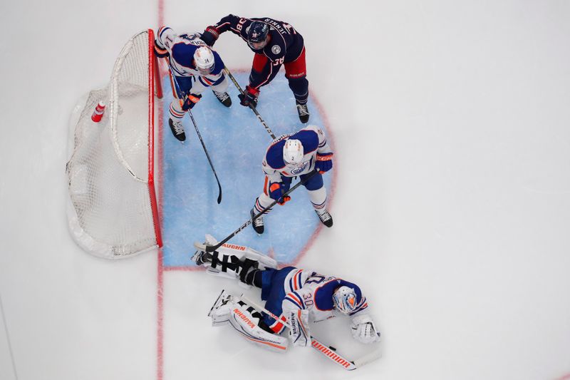 Mar 7, 2024; Columbus, Ohio, USA; Edmonton Oilers goalie Calvin Pickard (30) dives to cover a loose puck against the Columbus Blue Jackets during the second period at Nationwide Arena. Mandatory Credit: Russell LaBounty-USA TODAY Sports