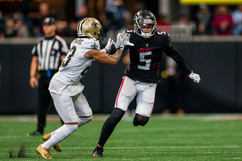 Atlanta Falcons wide receiver Drake London (5) works against New Orleans Saints cornerback Marshon Lattimore (23) during the first half of an NFL football game, Sunday, Sep. 11, 2022, in Atlanta. The New Orleans Saints won 27-26. (AP Photo/Danny Karnik)