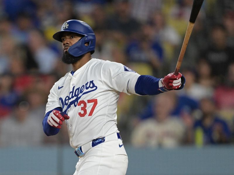 Aug 5, 2024; Los Angeles, California, USA;   Los Angeles Dodgers left fielder Teoscar Hernandez (37) hits a two-run home run in the third inning against the Philadelphia Phillies at Dodger Stadium. Mandatory Credit: Jayne Kamin-Oncea-USA TODAY Sports