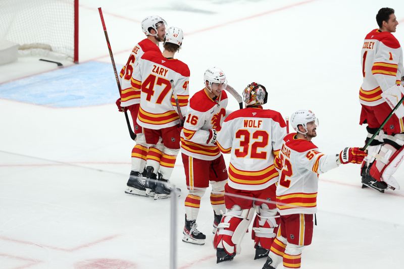 Dec 13, 2025; Los Angeles, California, USA;  Calgary Flames center Morgan Frost (16) celebrates with goaltender Dustin Wolf (32) after defeating the Los Angeles Kings in overtime at Crypto.com Arena. Mandatory Credit: Kiyoshi Mio-Imagn Images