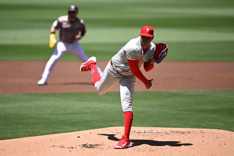 Apr 28, 2024; San Diego, California, USA; Philadelphia Phillies starting pitcher Taijuan Walker (center) throws a pitch as San Diego Padres first baseman Jake Cronenworth (left) leads off second base during the first inning at Petco Park. Mandatory Credit: Orlando Ramirez-USA TODAY Sports