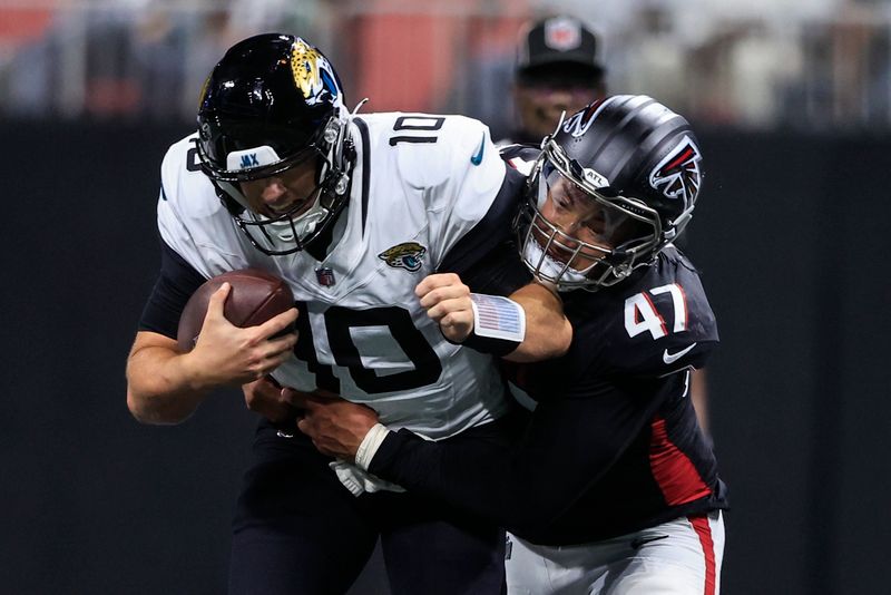 Atlanta Falcons linebacker Bradlee Anae (47) hits Jacksonville Jaguars quarterback Mac Jones (10) in the first half of an NFL preseason footballl game, Friday, Aug. 23, 2024, in Atlanta. (AP Photo/Butch Dill)