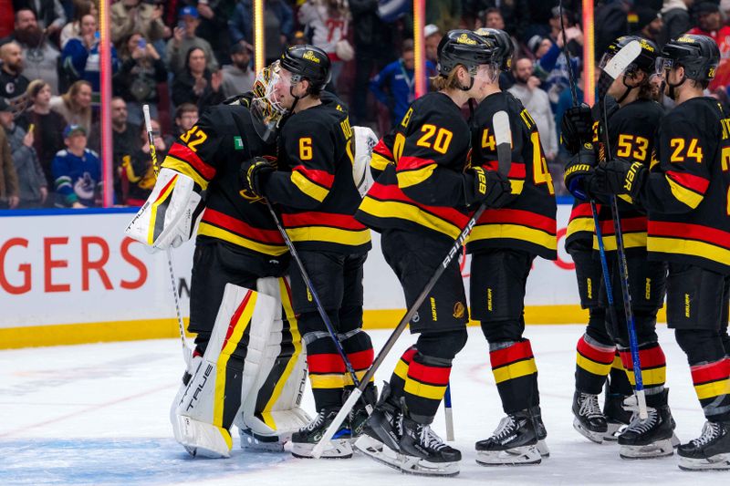 Jan 25, 2025; Vancouver, British Columbia, CAN; Vancouver Canucks goalie Kevin Lankinen (32) and forward Brock Boeser (6) and forward Danton Heinen (20) and celebrate their victory against the Washington Capitals at Rogers Arena. Mandatory Credit: Bob Frid-Imagn Images