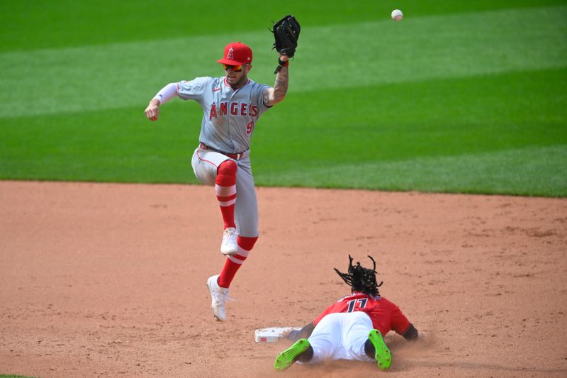 May 5, 2024; Cleveland, Ohio, USA; Cleveland Guardians third baseman Jose Ramirez (11) steals second base beside Los Angeles Angels shortstop Zach Neto (9) in the eighth inning at Progressive Field. Mandatory Credit: David Richard-USA TODAY Sports