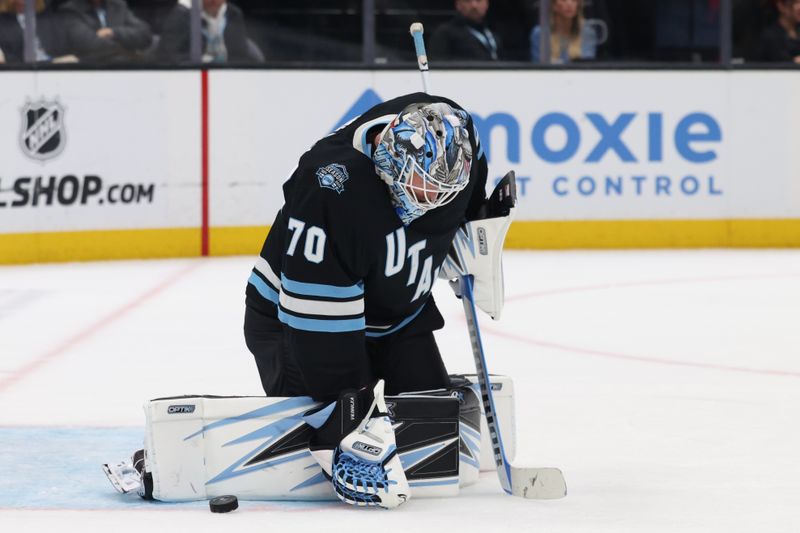 Apr 3, 2025; Salt Lake City, Utah, USA; Utah Hockey Club goaltender Karel Vejmelka (70) redirects a shot by the Los Angeles Kings during the third period at Delta Center. Mandatory Credit: Rob Gray-Imagn Images