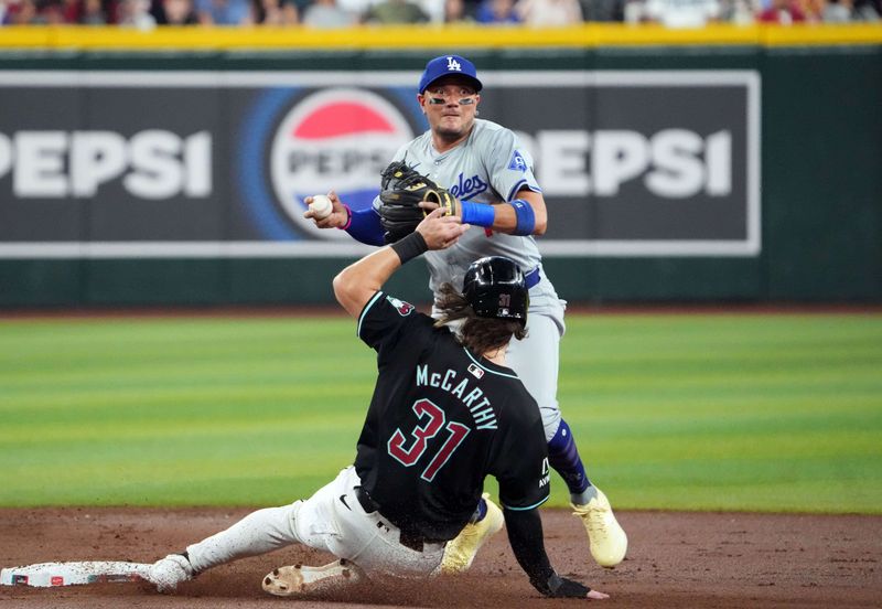 Sep 2, 2024; Phoenix, Arizona, USA; Arizona Diamondbacks catcher Jose Herrera (11) throws to first to double up Arizona Diamondbacks designated hitter Joc Pederson (not pictured) after forcing out Arizona Diamondbacks outfielder Jake McCarthy (31) at second during the first inning at Chase Field. Mandatory Credit: Joe Camporeale-USA TODAY Sports