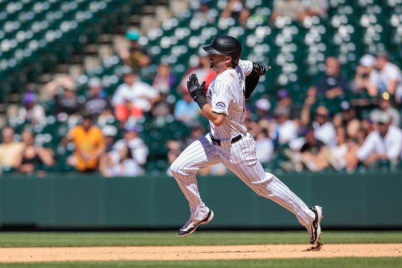 Jun 5, 2024; Denver, Colorado, USA; Colorado Rockies outfielder Jake Cave (11) hits an RBI double during the eighth inning against the Cincinnati Reds at Coors Field. Mandatory Credit: Andrew Wevers-USA TODAY Sports