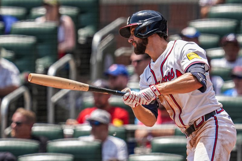 May 15, 2025; Cumberland, Georgia, USA; Atlanta Braves outfielder Eli White (36) hits a single to drive in a run against the Washington Nationals during the eighth inning at Truist Park. Mandatory Credit: Dale Zanine-Imagn Images