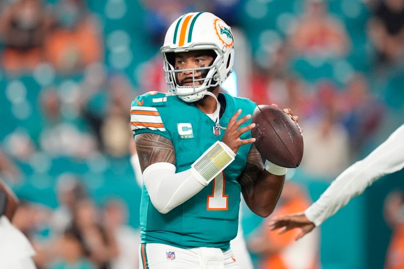 Miami Dolphins quarterback Tua Tagovailoa (1) throws before an NFL football game against the Buffalo Bills, Thursday, Sept. 12, 2024, in Miami Gardens, Fla. (AP Photo/Rebecca Blackwell)