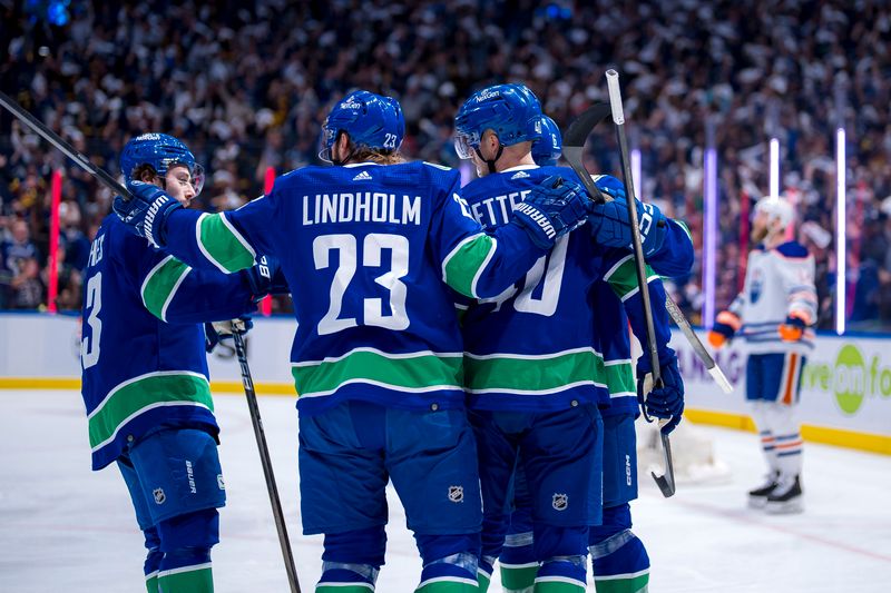 May 10, 2024; Vancouver, British Columbia, CAN; Vancouver Canucks defenseman Quinn Hughes (43) and  forward Brock Boeser (6) forward Elias Pettersson (40) and forward Elias Lindholm (23) celebrate Pettersson’s goal against the Edmonton Oilers during the first period in game two of the second round of the 2024 Stanley Cup Playoffs at Rogers Arena. Mandatory Credit: Bob Frid-USA TODAY Sports