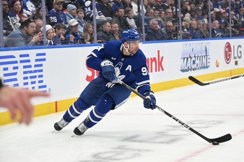 Nov 16, 2024; Toronto, Ontario, CAN;  Toronto Maple Leafs forward John Tavares (91) skates with the puck against the Edmonton Oilers in the second period at Scotiabank Arena. Mandatory Credit: Dan Hamilton-Imagn Images