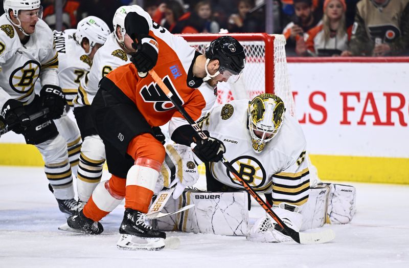 Jan 27, 2024; Philadelphia, Pennsylvania, USA; Boston Bruins goalie Linus Ullmark (35) covers the puck against Philadelphia Flyers left wing Joel Farabee (86) in the second period at Wells Fargo Center. Mandatory Credit: Kyle Ross-USA TODAY Sports