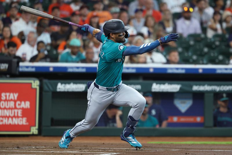 May 25, 2025; Houston, Texas, USA; Seattle Mariners center fielder Julio Rodriguez (44) hits a single during the first inning against the Houston Astros at Daikin Park. Mandatory Credit: Troy Taormina-Imagn Images
