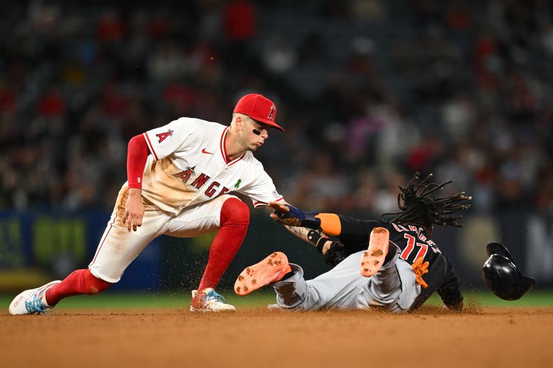 May 25, 2024; Anaheim, California, USA; Cleveland Guardians third baseman José Ramírez (11) fails to steal second base against Los Angeles Angels shortstop Zach Neto (9) during the eighth inning at Angel Stadium. Mandatory Credit: Jonathan Hui-USA TODAY Sports