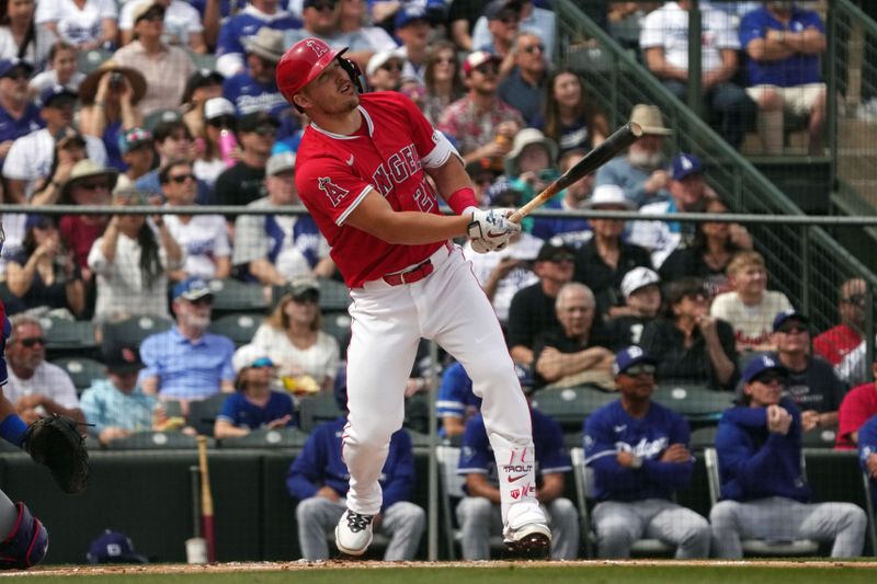 Mar 5, 2025; Tempe, Arizona, USA; Los Angeles Angels outfielder Mike Trout (27) hits a home run against the Los Angeles Dodgers in the first inning at Tempe Diablo Stadium. Mandatory Credit: Rick Scuteri-Imagn Images