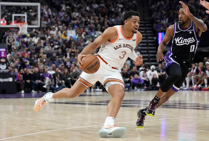 SACRAMENTO, CALIFORNIA - FEBRUARY 22: Keldon Johnson #3 of the San Antonio Spurs drives on Malik Monk #0 of the Sacramento Kings in the second quarter at Golden 1 Center on February 22, 2024 in Sacramento, California. NOTE TO USER: User expressly acknowledges and agrees that, by downloading and or using this photograph, User is consenting to the terms and conditions of the Getty Images License Agreement. (Photo by Thearon W. Henderson/Getty Images)