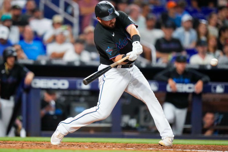 Aug 16, 2023; Miami, Florida, USA; Miami Marlins third baseman Jake Burger (36) hits a single against the Houston Astros during the fifth inning at loanDepot Park. Mandatory Credit: Rich Storry-USA TODAY Sports