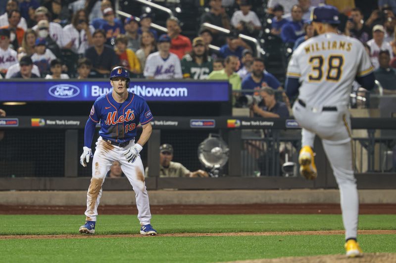 Jun 29, 2023; New York City, New York, USA; New York Mets left fielder Mark Canha (19) leads off third base as Milwaukee Brewers relief pitcher Devin Williams (38) delivers a pitch during the ninth inning at Citi Field. Mandatory Credit: Vincent Carchietta-USA TODAY Sports