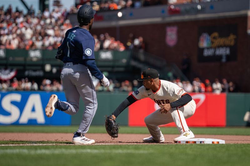 Apr 6, 2025; San Francisco, California, USA; Seattle Mariners second baseman Ryan Bliss (1) is thrown out in a double play ending the inning with San Francisco Giants first baseman LaMonte Wade Jr. (31) during the eighth inning at Oracle Park. Mandatory Credit: Neville E. Guard-Imagn Images