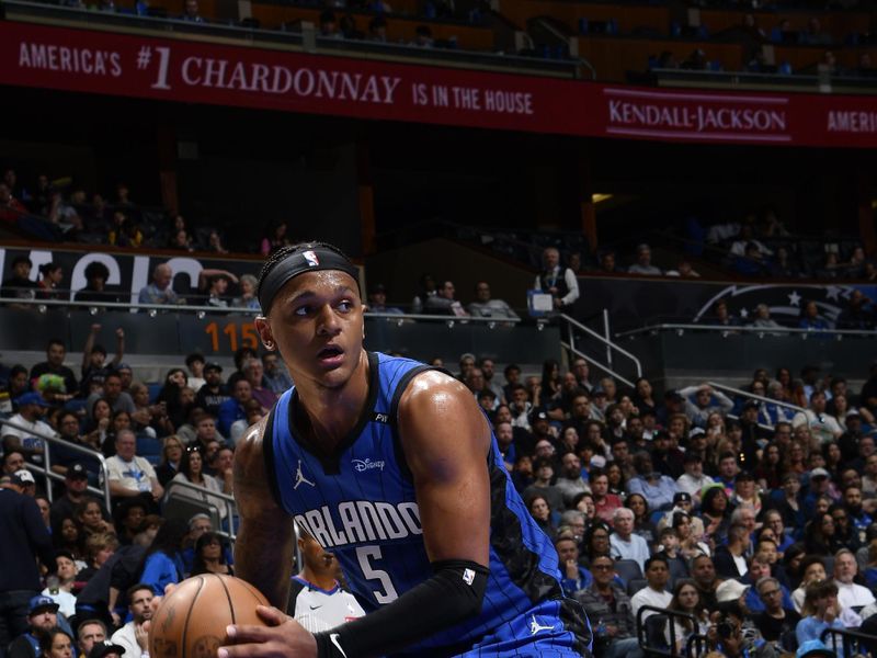 ORLANDO, FL - FEBRUARY 23:  Paolo Banchero #5 of the Orlando Magic handles the ball during the game against the Washington Wizards on February 23, 2025 at Kia Center in Orlando, Florida. NOTE TO USER: User expressly acknowledges and agrees that, by downloading and or using this photograph, User is consenting to the terms and conditions of the Getty Images License Agreement. Mandatory Copyright Notice: Copyright 2025 NBAE (Photo by Fernando Medina/NBAE via Getty Images)